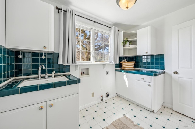 clothes washing area with sink, gas dryer hookup, cabinets, hookup for a washing machine, and electric dryer hookup