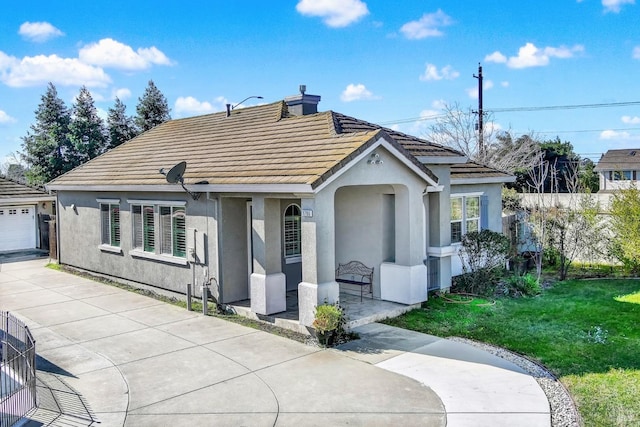 ranch-style home featuring a porch, a front yard, and a garage