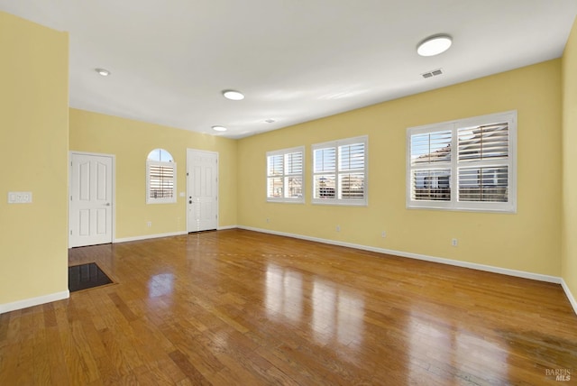 spare room featuring wood-type flooring