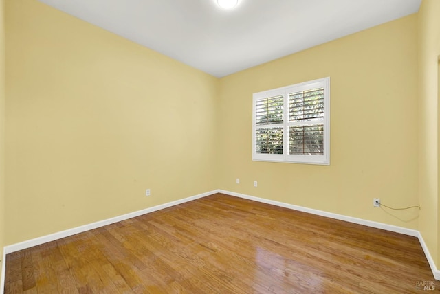 empty room with hardwood / wood-style floors