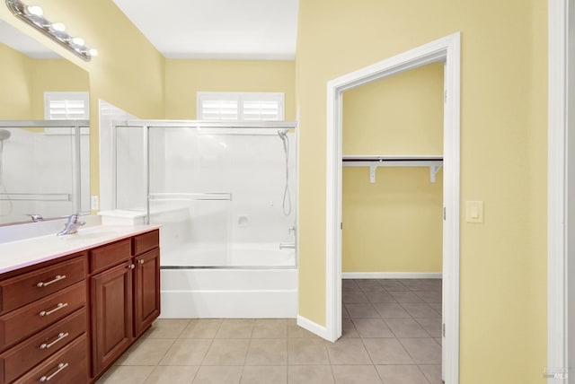 bathroom featuring tile patterned flooring, shower with separate bathtub, and vanity