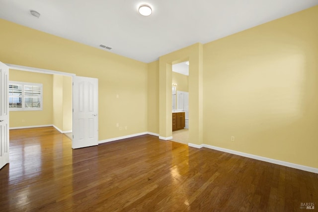 spare room with dark hardwood / wood-style flooring