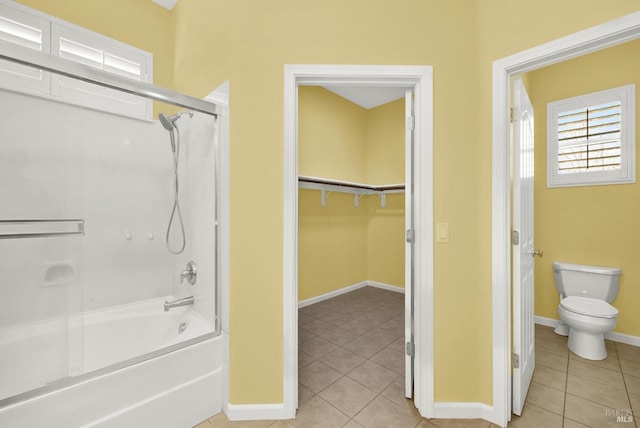 bathroom featuring tile patterned floors, toilet, and shower / bath combination