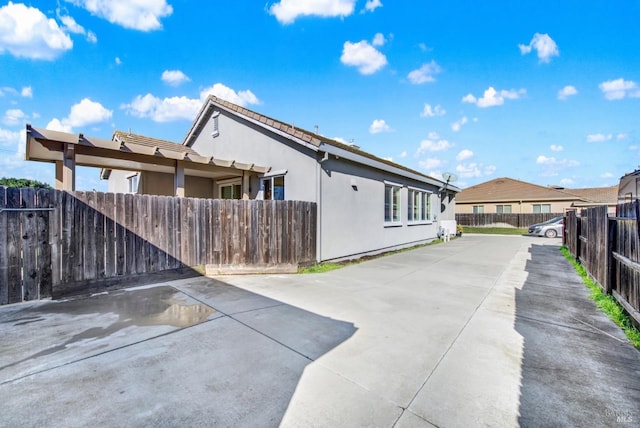 view of side of property featuring a patio