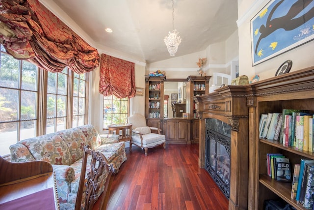 living room with a notable chandelier, vaulted ceiling, and dark hardwood / wood-style floors