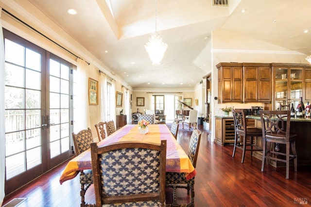 dining room featuring french doors, ornamental molding, and dark hardwood / wood-style flooring