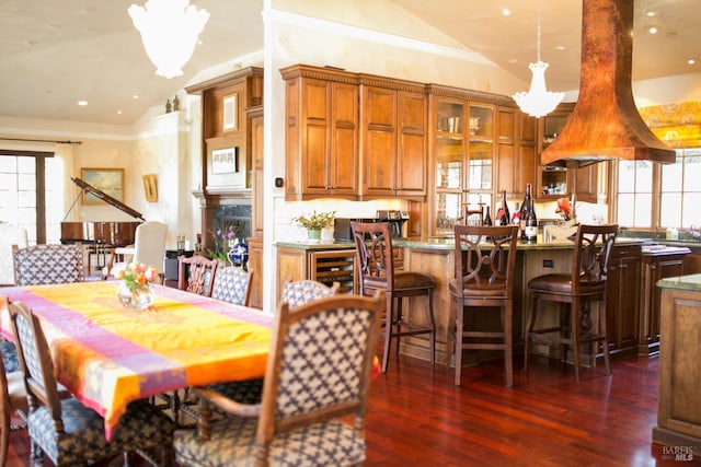 dining room with vaulted ceiling and dark hardwood / wood-style floors