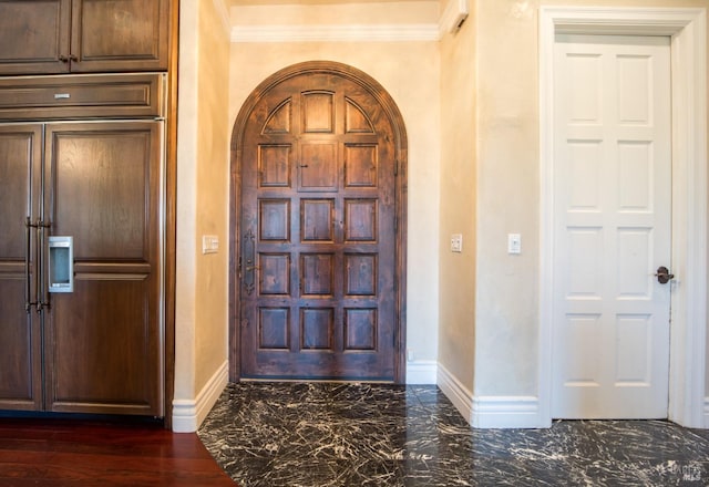 foyer entrance featuring ornamental molding