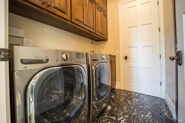 washroom featuring cabinets and independent washer and dryer