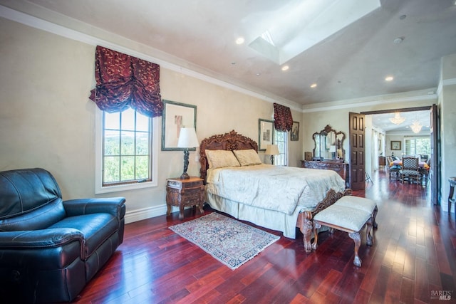 bedroom with ornamental molding, dark hardwood / wood-style floors, and a skylight