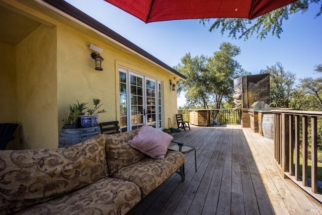 wooden deck with area for grilling and french doors