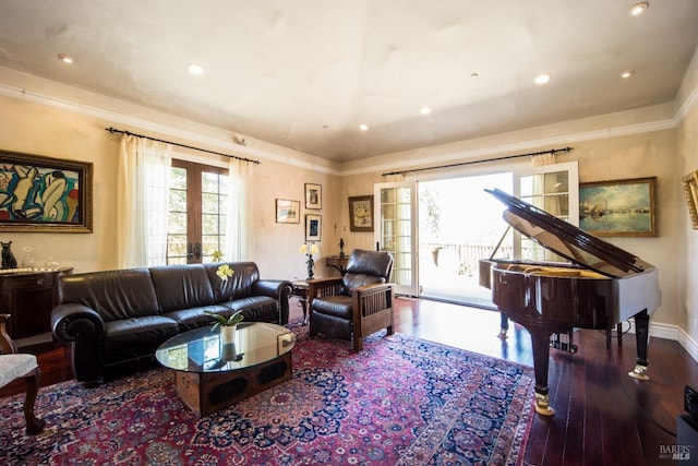 living room with ornamental molding, dark hardwood / wood-style floors, and french doors