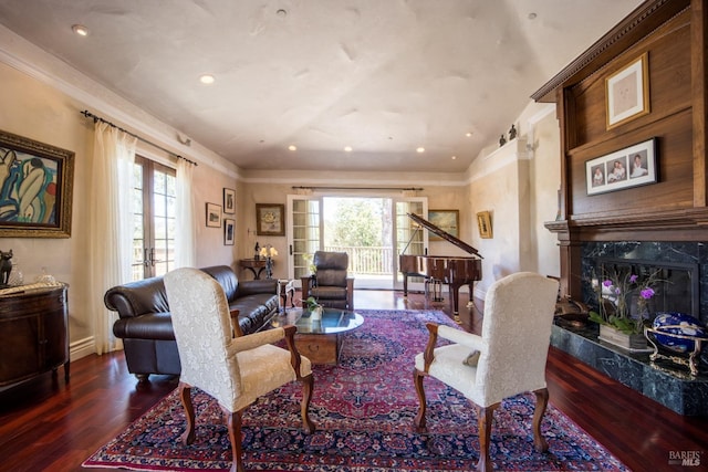 living room with dark hardwood / wood-style flooring, lofted ceiling, a premium fireplace, and french doors