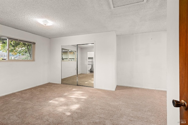 unfurnished bedroom with a closet, a textured ceiling, and carpet flooring