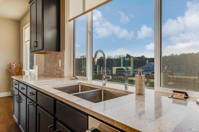 2228 Chateau Ct, Santa Rosa, CA 95404 - kitchen featuring light stone counters, a wealth of natural light, a sink, and tasteful backsplash