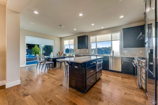2228 Chateau Ct, Santa Rosa, CA 95404 - kitchen featuring light countertops, appliances with stainless steel finishes, a kitchen island, and under cabinet range hood