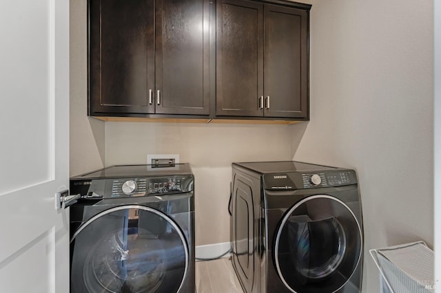2228 Chateau Ct, Santa Rosa, CA 95404 - laundry room with light wood-type flooring, independent washer and dryer, cabinet space, and baseboards