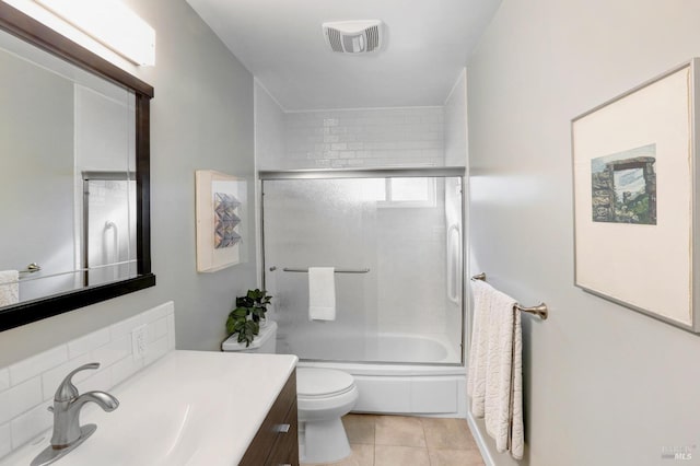 full bathroom with toilet, visible vents, tile patterned flooring, vanity, and enclosed tub / shower combo