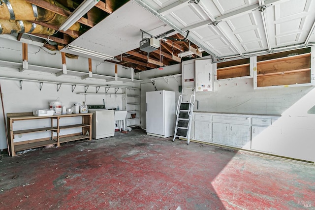 garage featuring sink, washer / clothes dryer, a garage door opener, and white refrigerator