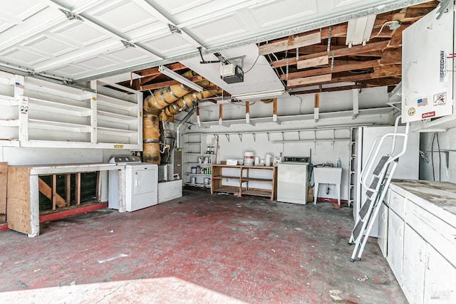 garage with washing machine and dryer, sink, and a garage door opener