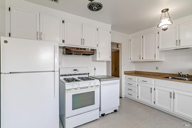 kitchen featuring sink, white appliances, white cabinetry, and pendant lighting