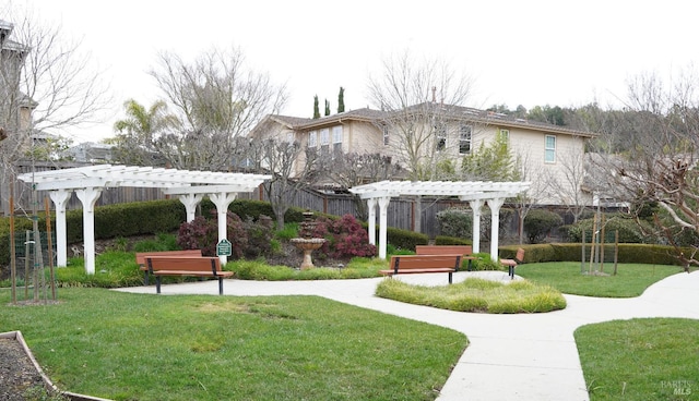 view of community with a yard and a pergola