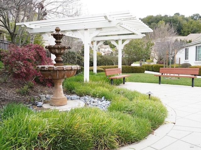 view of community featuring a pergola and a patio area