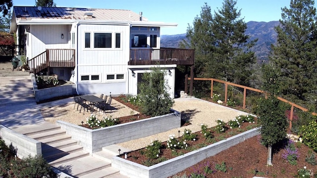 view of front of property featuring a balcony and a mountain view