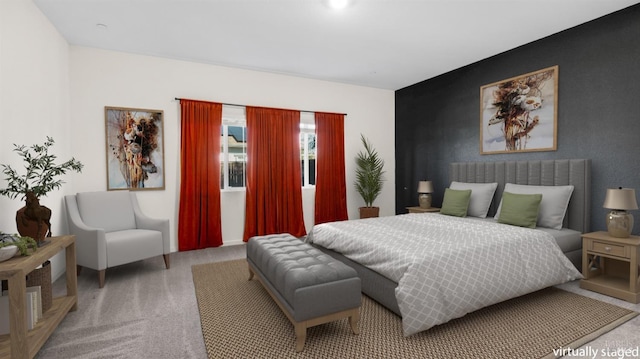 bedroom featuring an accent wall and carpet flooring