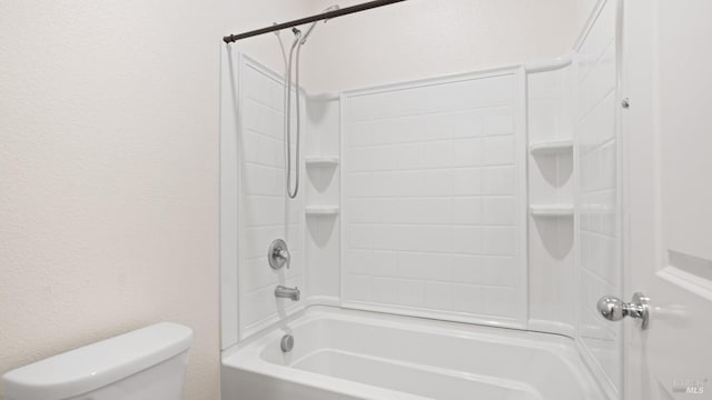 bathroom featuring a textured wall, toilet, and shower / washtub combination