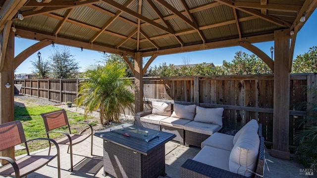 view of patio / terrace featuring a gazebo, a fenced backyard, and an outdoor living space