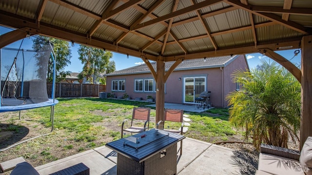 view of patio / terrace featuring a gazebo, central AC unit, a fenced backyard, and a trampoline