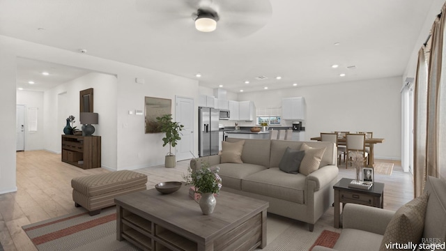 living room featuring light wood-style floors, recessed lighting, baseboards, and ceiling fan