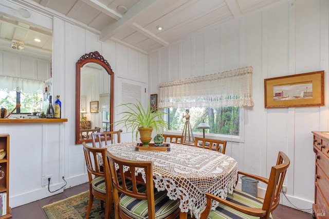 dining area with lofted ceiling with beams and a wealth of natural light