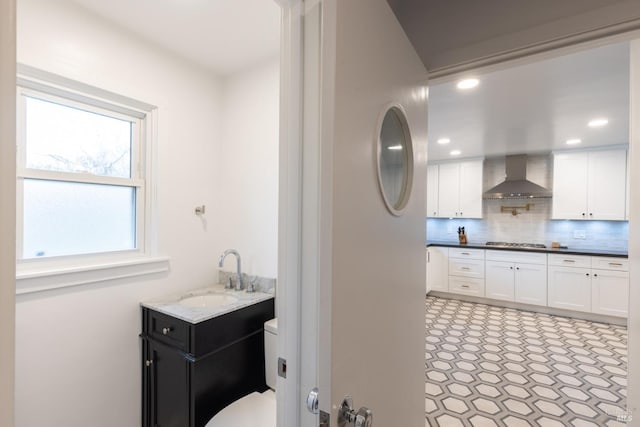 bathroom with toilet, recessed lighting, vanity, backsplash, and tile patterned floors