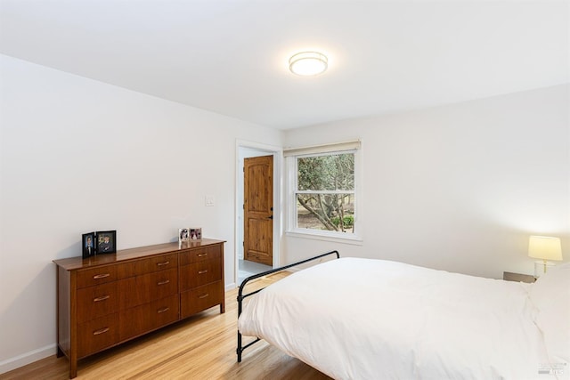 bedroom featuring light wood-type flooring and baseboards