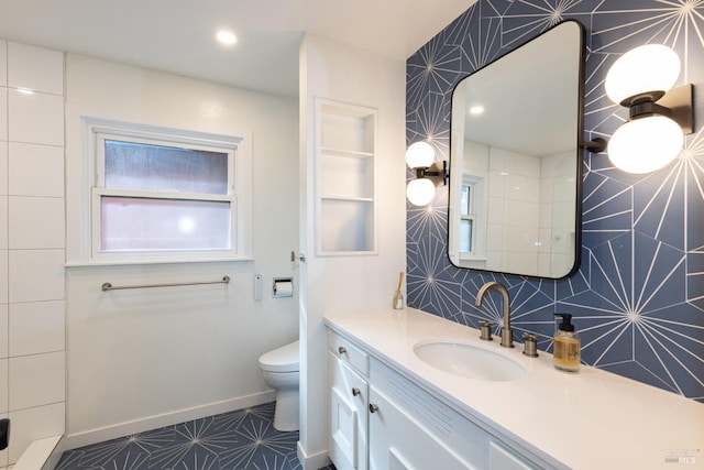 full bathroom featuring toilet, recessed lighting, tile walls, vanity, and baseboards