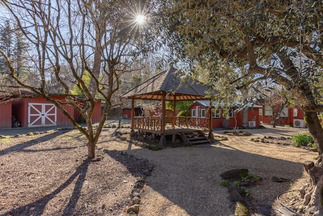 back of property featuring a wooden deck and an outdoor structure