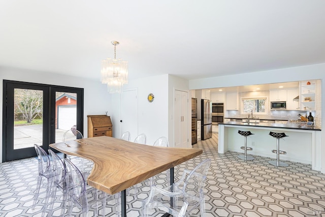 dining space with a notable chandelier and french doors