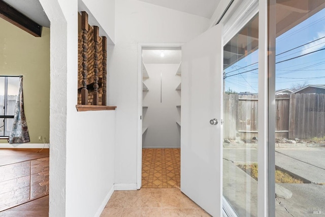 hallway featuring lofted ceiling