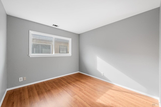 spare room with wood-type flooring