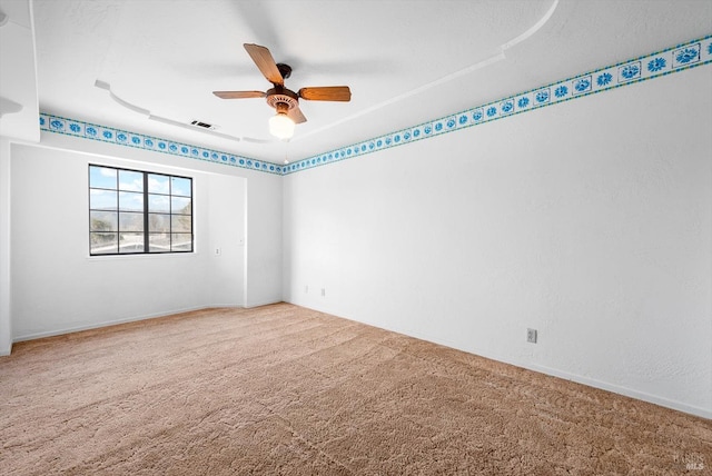 spare room featuring carpet floors and ceiling fan