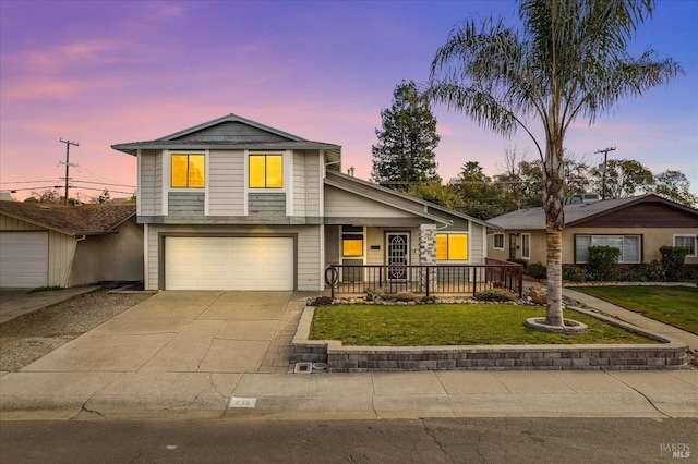 view of front of property featuring a garage and a lawn