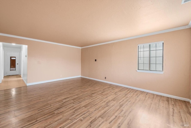 empty room with ornamental molding, a textured ceiling, and light hardwood / wood-style floors