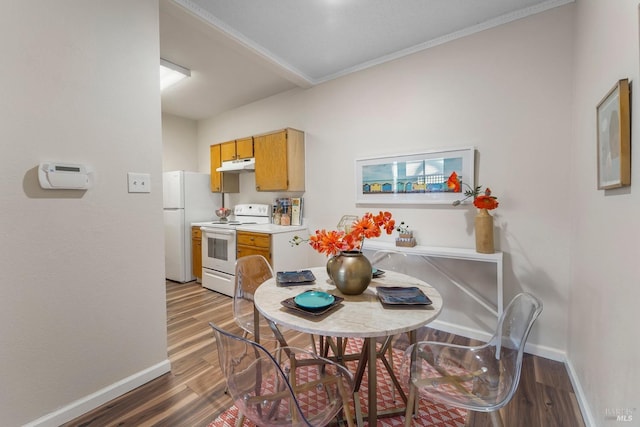 dining space featuring wood finished floors and baseboards