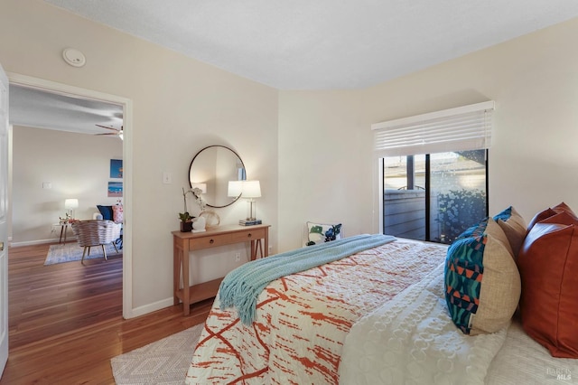 bedroom featuring baseboards and wood finished floors