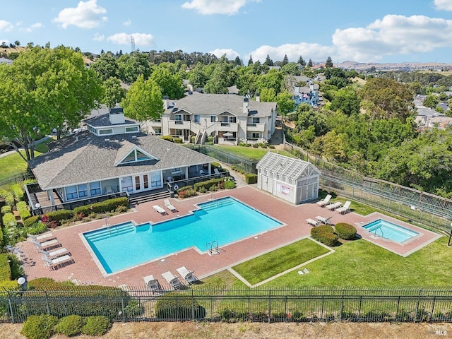 community pool featuring a yard, a patio area, and a fenced backyard