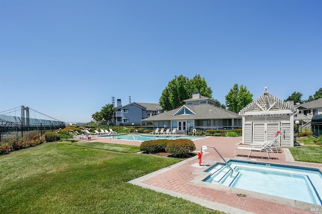 pool with a yard, a patio area, and fence