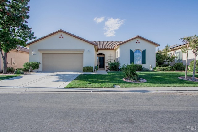 mediterranean / spanish house featuring stucco siding, driveway, a front lawn, an attached garage, and a tiled roof