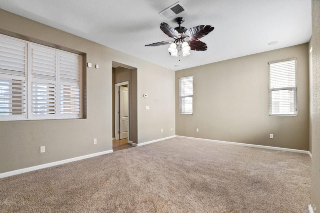 spare room featuring ceiling fan and carpet floors